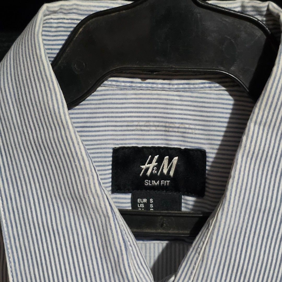 H&M Slim Fit Men's Shirts (2 pcs) (Category: Tshirts & Polo Shirts ) located in Manila. Submitted by etc.06 (Listing ID 1460404502, Image 2). Description: - Two H&M long-sleeved button-down shirts - Style 1: Light blue with thin pinstripes - Style 2: Black and white gingham check - Slim fit design - Versatile for casual and smart casual occasions - Great value when buying both shirts.