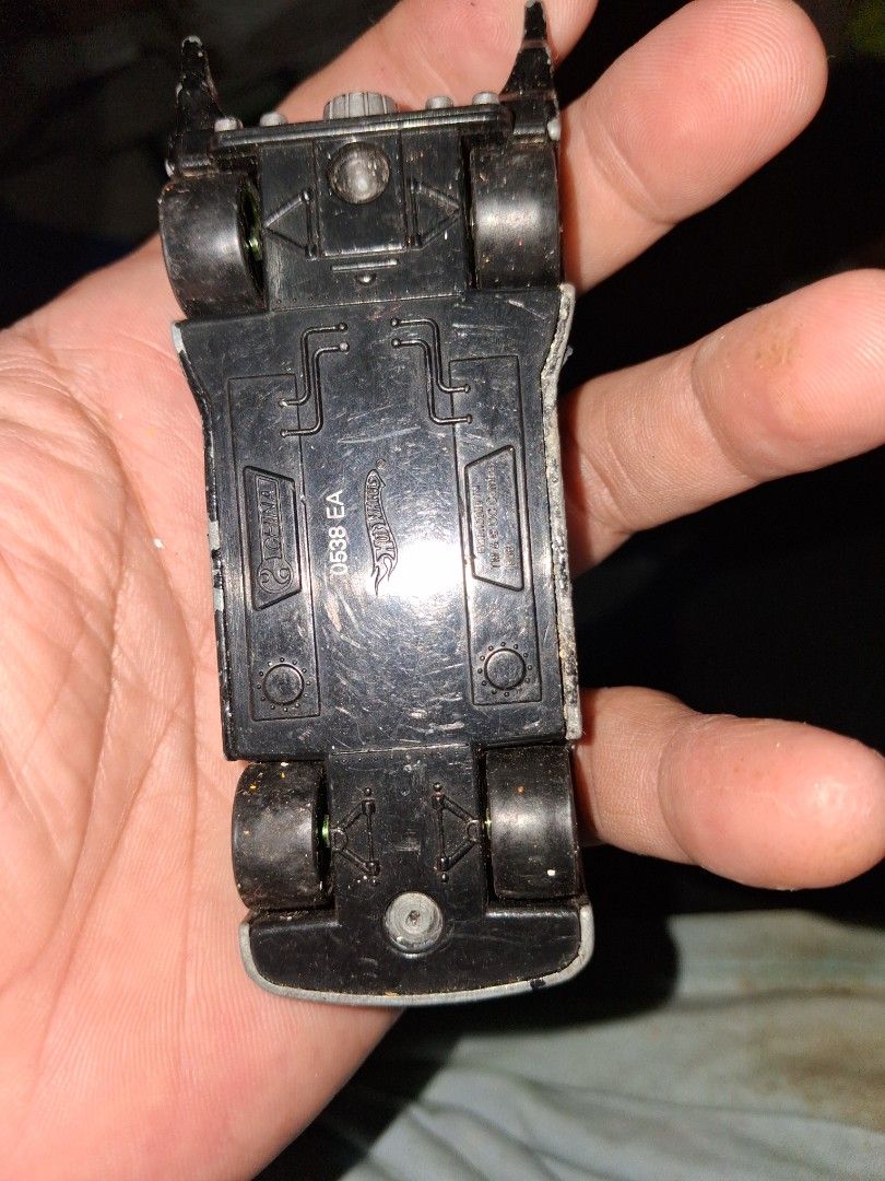 Hot Wheels Batman Batmobile Toy Car (Category: Vehicle & Diecast Models) located in Manila. Submitted by marcas022798212 (Listing ID 1460444915, Image 2). Description: - Classic Hot Wheels Batmobile toy car - Black die-cast metal construction - Shows some dust and wear from play, adding character - Wheels still roll smoothly - Ideal for any Batman fan's collection - Great for display or play.
