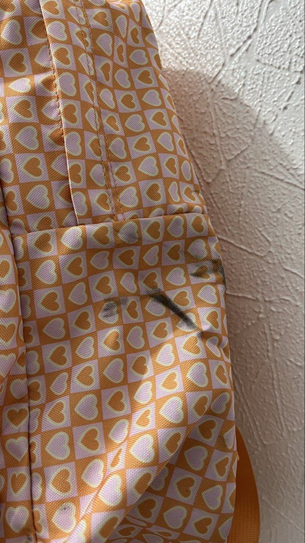 Jansport Backpack Orange Heart Pattern (Category: Backpacks) located in Naga. Submitted by lilycheedeclutter (Listing ID 1460488694, Image 3). Description: HAS STAIN bc of my dark denim pants but can be removed by washing Can fit 15” gaming laptop RFS: Too many bags Bought for 2.4k Used less than 20 times.