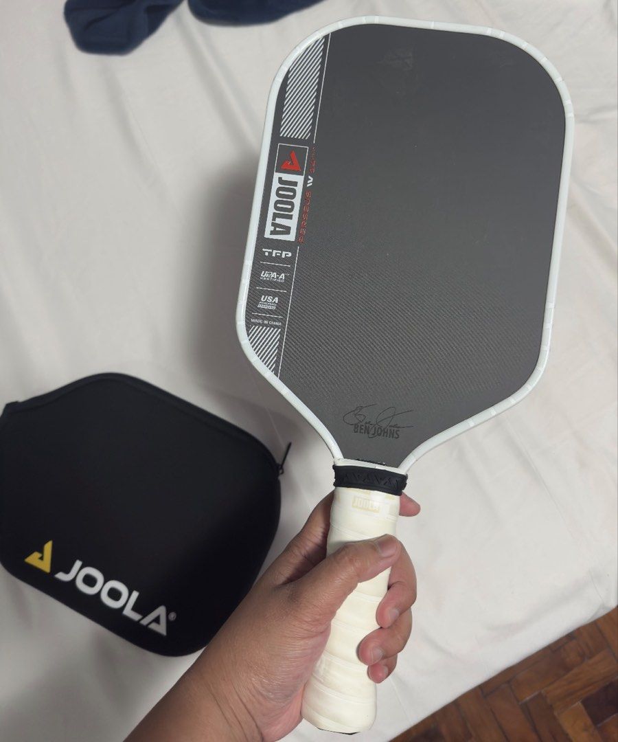 Joola Pro IV Perseus elongated 14mm (Category: Racket and Ball Sports) located in Pasig City. Submitted by mswise (Listing ID 1460457660, Image 2). Description: The JOOLA Ben Johns Perseus Pro IV is a premium, high-performance pickleball paddle designed for advanced and professional players. It is the signature model for world number one Ben Johns, combining an elongated shape with explosive power and precise ball placement. New handle grips and 