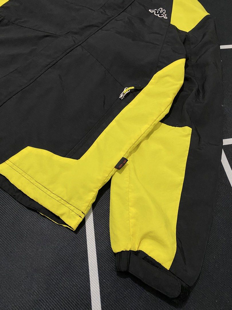 Kappa Track Jacket Black Yellow Logo Tech (Category: Coats, Jackets and Outerwear) located in Cateel. Submitted by khan.find_ (Listing ID 1460329584, Image 2). Description: - Stylish black and yellow Kappa jacket - Features iconic Kappa logo on chest and sleeves - 'K TECH' detail on the front - Hooded design with adjustable yellow drawstrings - Elasticated cuffs and hem for a snug fit - Ideal for casual outings or athletic activities.