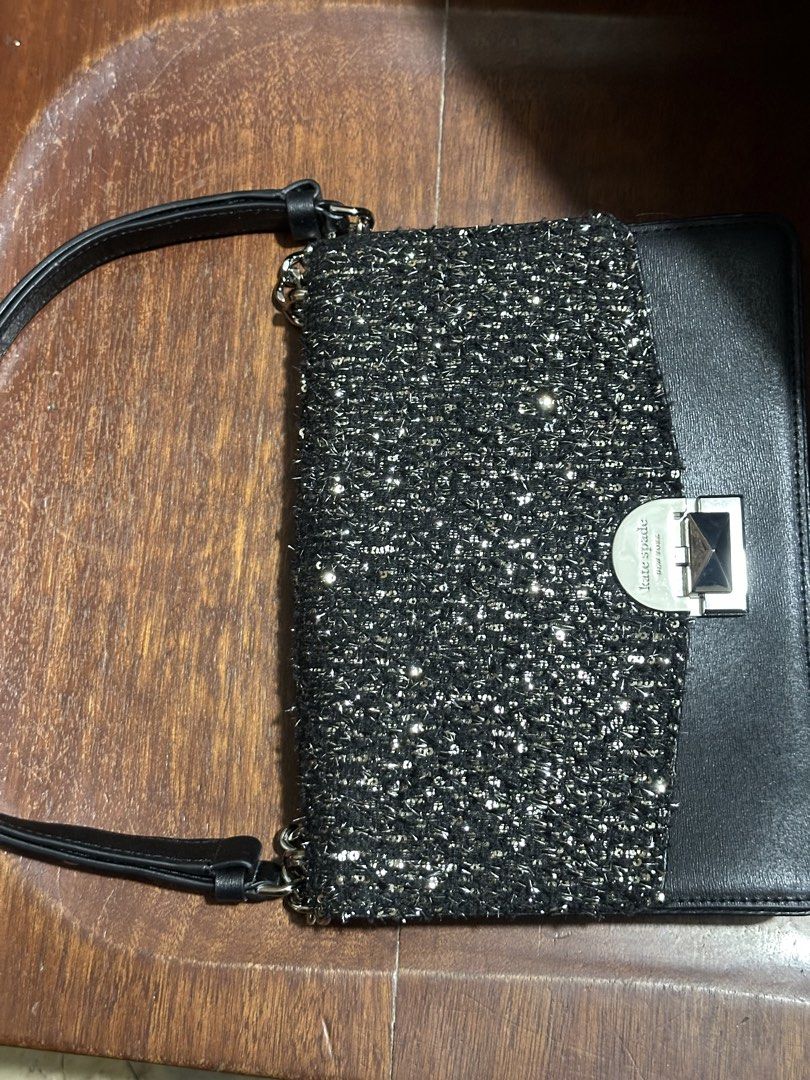 Kate Spade Black Tweed & Leather Shoulder Bag (Category: Shoulder Bags) located in Makati City. Submitted by alpacaborahae (Listing ID 1460414852, Image 2). Description: - Elegant black leather and tweed shoulder bag - Features a sparkly tweed front panel - Secure silver clasp closure with Kate Spade New York logo - Versatile chain and leather strap - Ideal for evening events or adding flair to any outfit.
