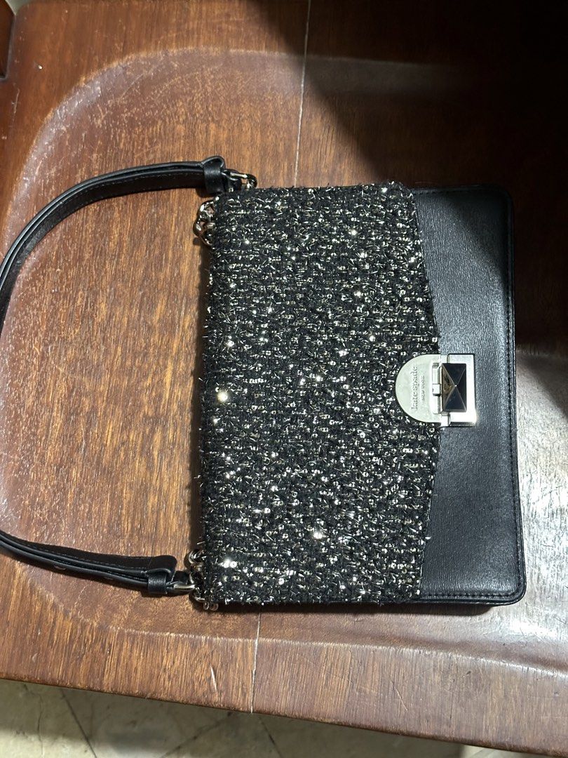 Kate Spade Black Tweed & Leather Shoulder Bag (Category: Shoulder Bags) located in Makati City. Submitted by alpacaborahae (Listing ID 1460414852, Image 1). Description: - Elegant black leather and tweed shoulder bag - Features a sparkly tweed front panel - Secure silver clasp closure with Kate Spade New York logo - Versatile chain and leather strap - Ideal for evening events or adding flair to any outfit.