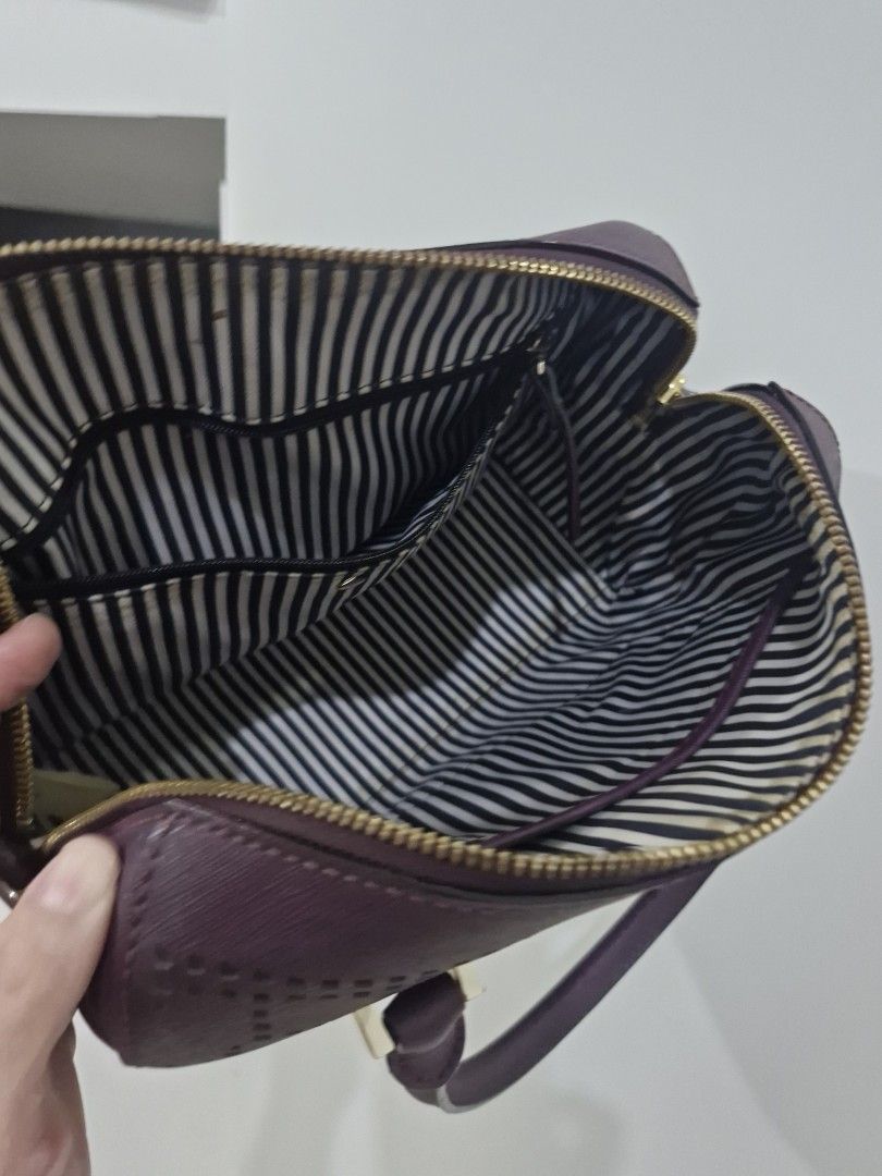 Kate Spade Perforated Satchel Handbag (Category: Luxury Bags & Wallets) located in Valenzuela. Submitted by eunze (Listing ID 1460377143, Image 2). Description: - Authentic Purple Kate Spade Handbag - Unique all-over perforated design - Secure zip closure - Interior features classic striped lining and convenient pockets - Comfortable top handles - Elegant gold hardware details - Ideal for everyday style and practicality.