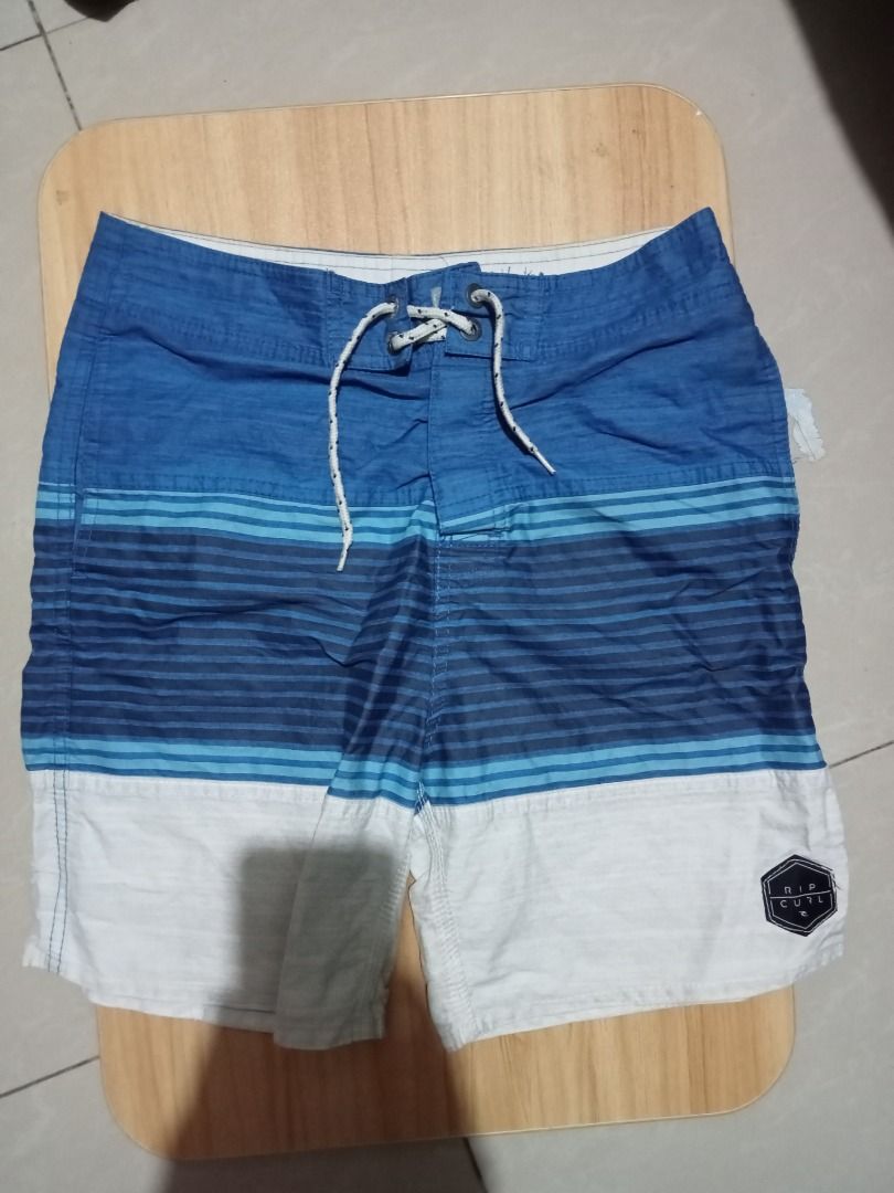 Kid's branded shorts (Category: Swim Trunks & Board Shorts) located in Caloocan City. Submitted by micsstore (Listing ID 1460503071, Image 3). Description: - Yellow DC Shoes board shorts - Features a large DC logo on the right leg - Includes a convenient cargo pocket on the left side - Drawstring waist ensures a secure and adjustable fit - Ideal for beach days, swimming, or everyday casual wear.