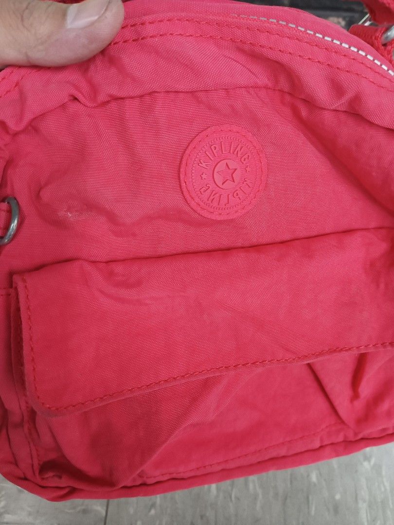 Kipling Red Nylon Crossbody Bag (Category: Cross-body Bags) located in Quezon City. Submitted by arvietekto (Listing ID 1460319951, Image 3). Description: Kipling 3way bag - Red Kipling crossbody bag - Durable nylon material - Front pocket with flap closure - Main compartment with zipper - Adjustable strap for comfort - Silver hardware details - Ideal for everyday use - Compact and practical design.
