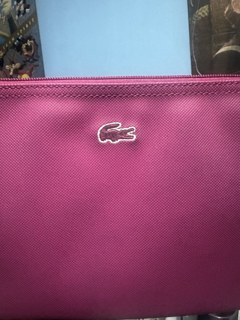 Lacoste Pink Crossbody Bag (Category: Cross-body Bags) located in Quezon City. Submitted by toni.rose (Listing ID 1460415182, Image 2). Description: - Pink Lacoste crossbody bag - Features iconic crocodile logo on the front - Interior lining with all-over Lacoste branding - Includes a long, adjustable strap - Ideal for everyday wear and convenience.