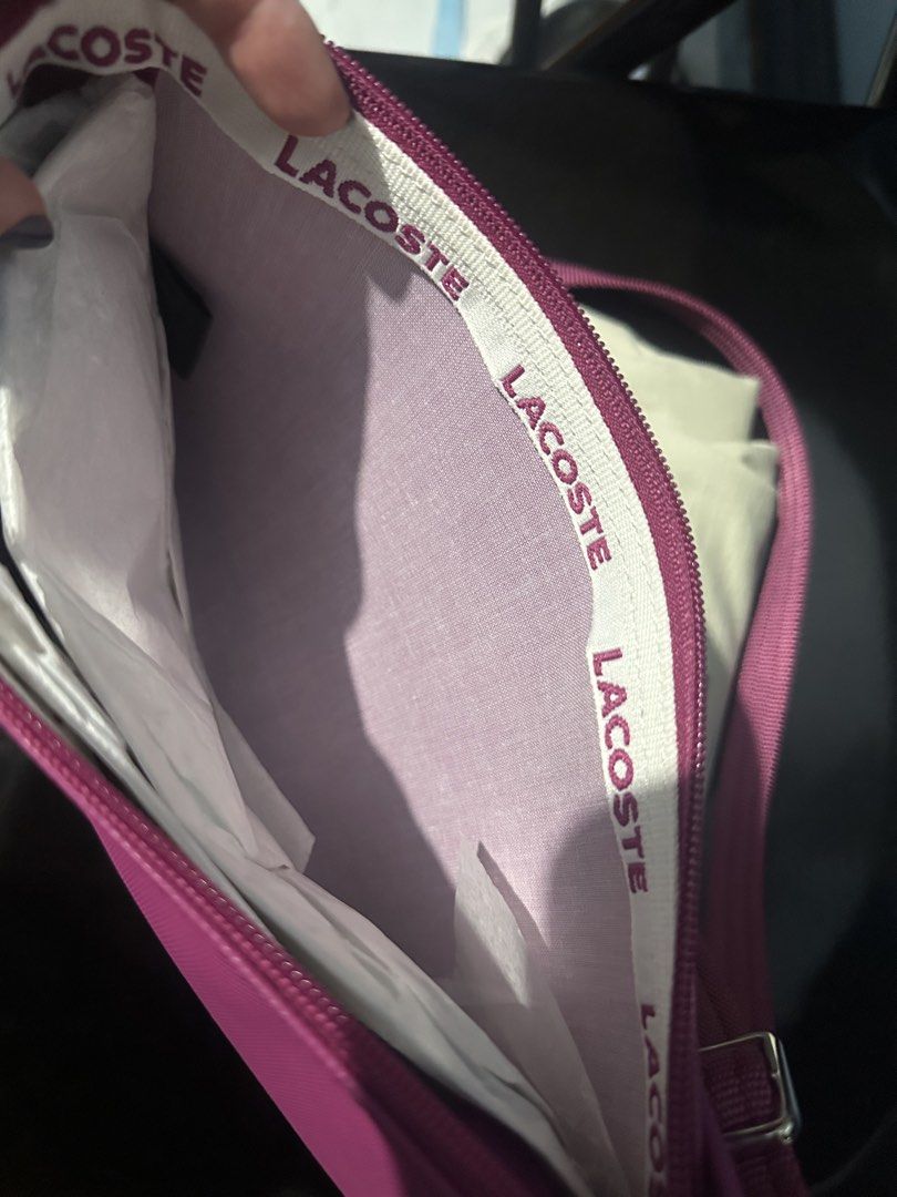 Lacoste Pink Crossbody Bag (Category: Cross-body Bags) located in Quezon City. Submitted by toni.rose (Listing ID 1460415182, Image 3). Description: - Pink Lacoste crossbody bag - Features iconic crocodile logo on the front - Interior lining with all-over Lacoste branding - Includes a long, adjustable strap - Ideal for everyday wear and convenience.