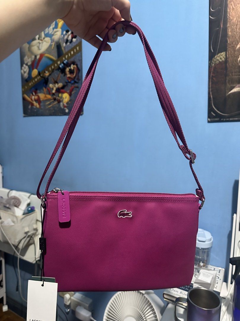 Lacoste Pink Crossbody Bag (Category: Cross-body Bags) located in Quezon City. Submitted by toni.rose (Listing ID 1460415182, Image 1). Description: - Pink Lacoste crossbody bag - Features iconic crocodile logo on the front - Interior lining with all-over Lacoste branding - Includes a long, adjustable strap - Ideal for everyday wear and convenience.