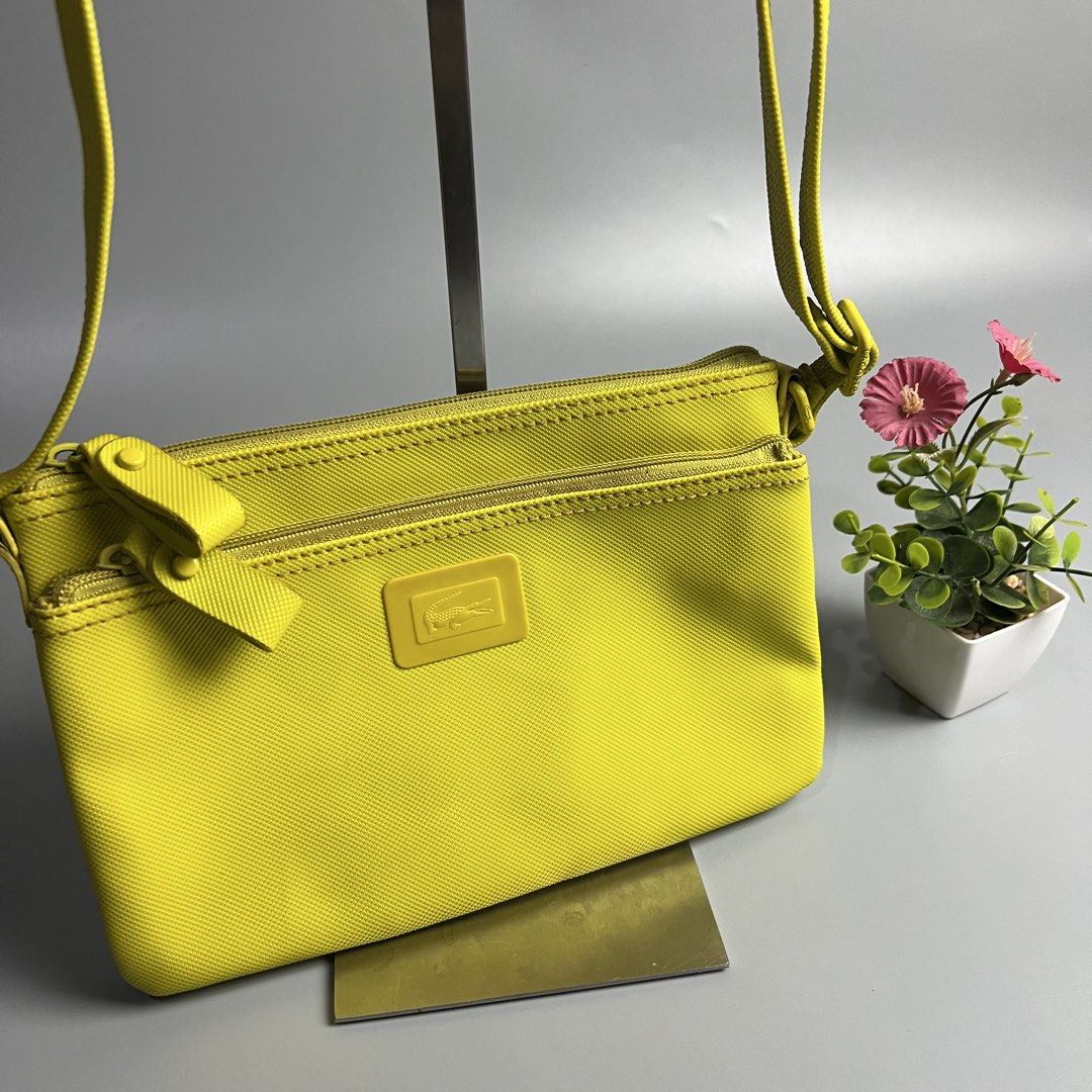 Lacoste Yellow Crossbody Bag (Category: Cross-body Bags) located in Bago City. Submitted by g___shop (Listing ID 1460437969, Image 3). Description: - Bright yellow Lacoste crossbody bag - Features two zippered compartments on the front - Adjustable strap with embossed Lacoste logo on hardware - Ideal for everyday use or travel - Small and compact design.