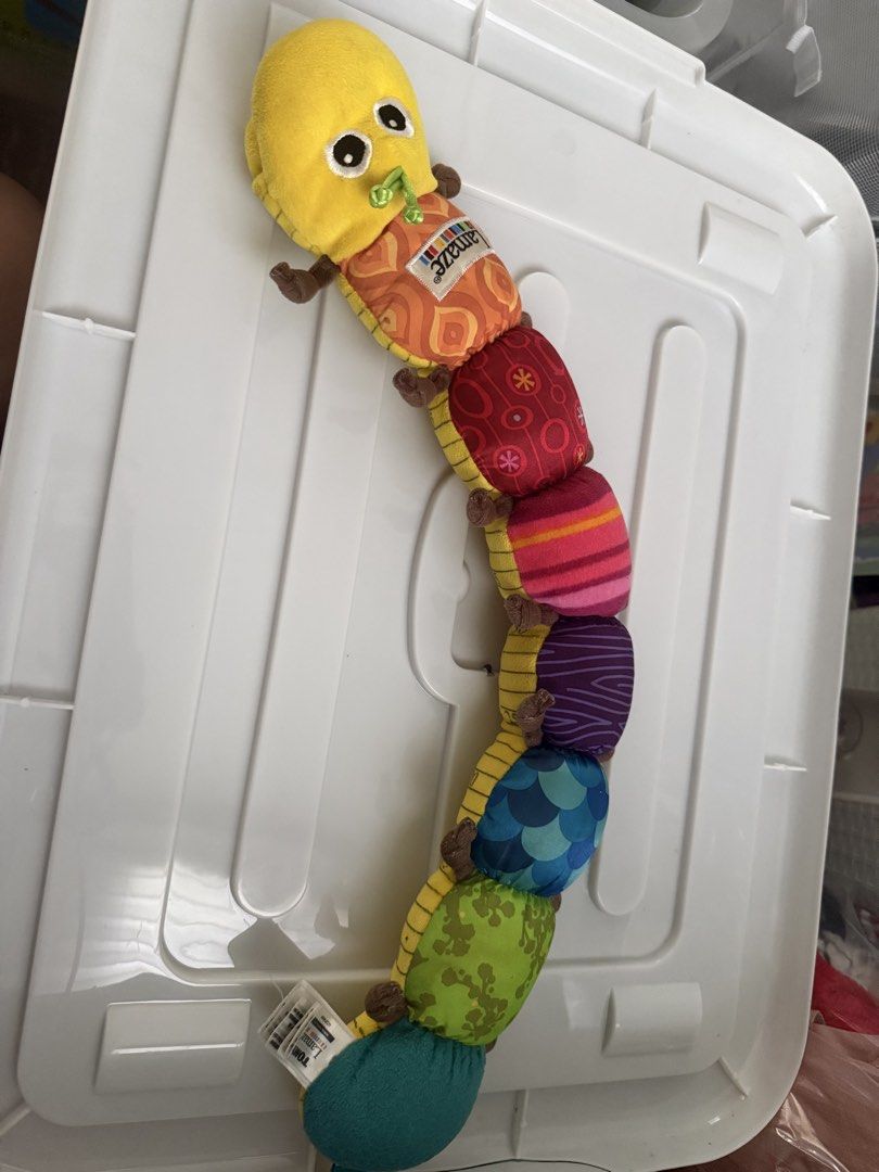 Lamaze Musical Caterpillar Soft Toy (Category: Infant Playtime) located in Bacoor. Submitted by annemargarett (Listing ID 1460388274, Image 1). Description: - Lamaze soft caterpillar toy - Features bright colors and fun patterns - Multiple textured segments for sensory exploration - Cute yellow head with friendly eyes and green mouth - Perfect for tummy time and on-the-go play.