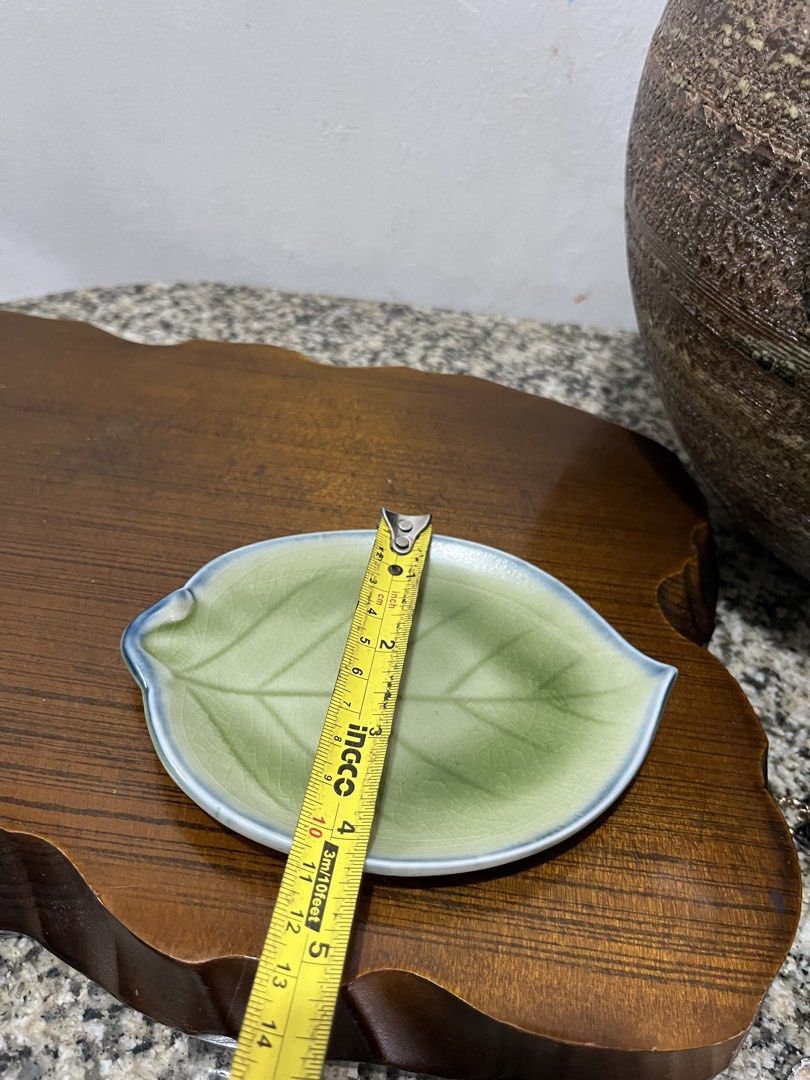 Leaf shaped ceramic trinket dish with gold keychain. ,3 leaf available (Category: Dinnerware & Cutlery) located in Taguig. Submitted by minmin_parker (Listing ID 1460392006, Image 3). Description: - Adorable leaf-shaped dish - Ideal for rings, earrings, or small trinkets - Features a charming light green glaze - Accented with a delicate blue rim - Comes with a stylish gold keychain - Adds a decorative touch to dressers or entryway tables.