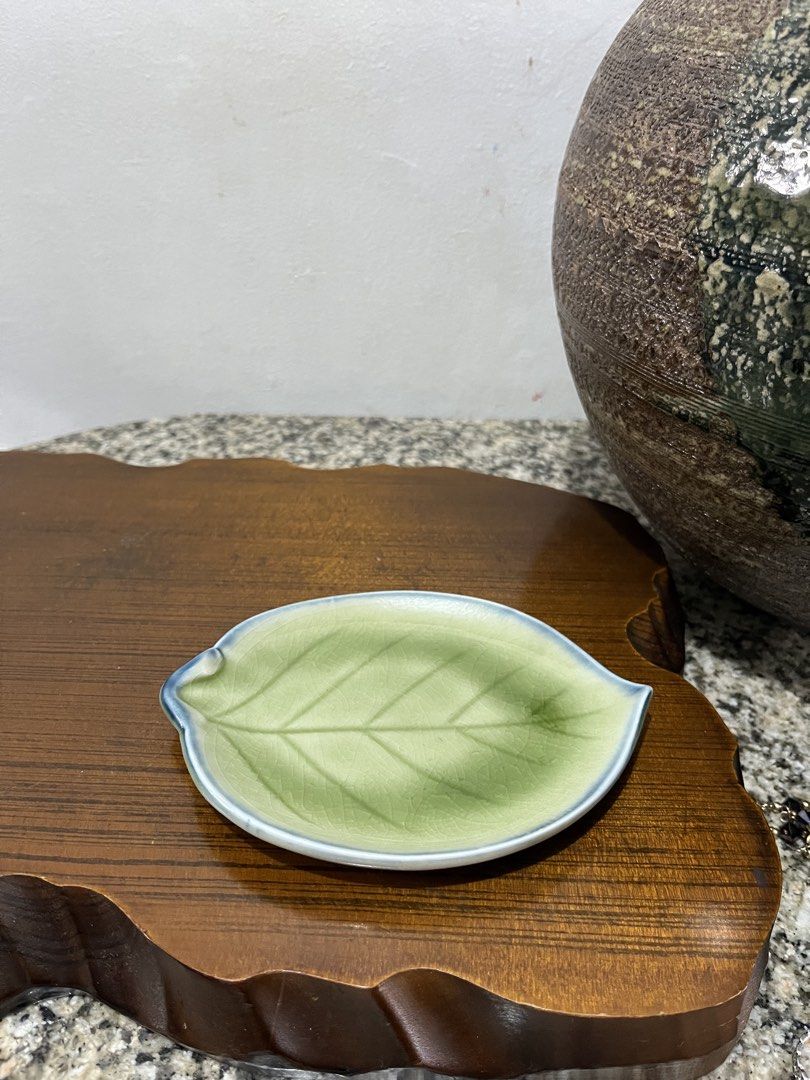 Leaf shaped ceramic trinket dish with gold keychain. ,3 leaf available (Category: Dinnerware & Cutlery) located in Taguig. Submitted by minmin_parker (Listing ID 1460392006, Image 1). Description: - Adorable leaf-shaped dish - Ideal for rings, earrings, or small trinkets - Features a charming light green glaze - Accented with a delicate blue rim - Comes with a stylish gold keychain - Adds a decorative touch to dressers or entryway tables.