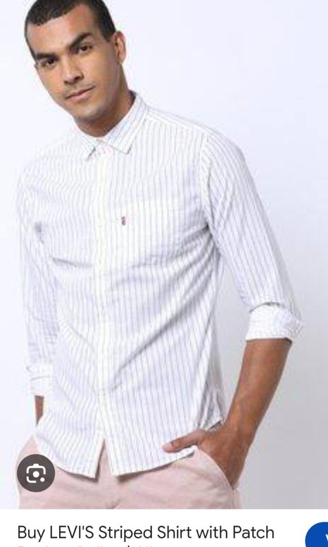 Levi's Slim Fit Striped Button-Up Shirt Medium (Category: Tshirts & Polo Shirts ) located in Plaridel. Submitted by igieperez147282 (Listing ID 1460343564, Image 2). Description: - White Levi's shirt with thin dark stripes - Slim fit style - Size: Medium - Measurements: 20" pit to pit, 27" length - Button-up front with a chest pocket - Classic Levi's red tab detail - Versatile for casual or smart casual outfits.