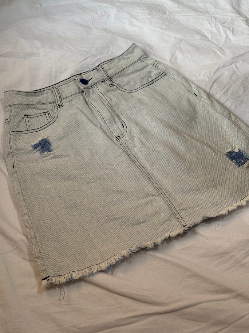 Light Wash Distressed Denim Mini Skirt (Category: Skirts) located in Pasay City. Submitted by nicoletlntn_ (Listing ID 1460480867, Image 1). Description: - Light wash denim mini skirt - Frayed hem and distressed front details - Classic 5-pocket styling - Button and zip closure - Versatile for casual outfits with t-shirts or crop tops.