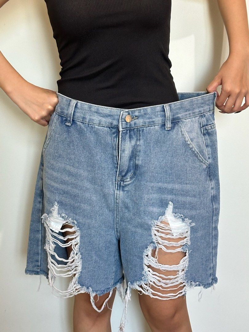 Light Wash Ripped Denim Bermuda Shorts (Category: Shorts) located in Pasay City. Submitted by nicoletlntn_ (Listing ID 1460445813, Image 2). Description: - Light wash denim shorts - Knee-length cut - Distressed rips on both legs - Frayed hemline - Button and zip closure - Classic five-pocket styling - Casual and comfortable for everyday wear.