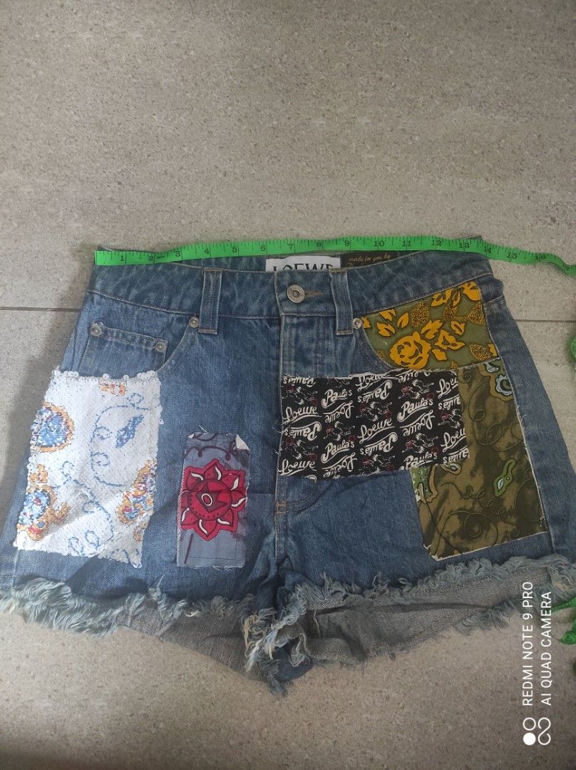 LOEWE Patchwork Denim Shorts (Category: Shorts) located in Santa Rosa. Submitted by y2kstylist (Listing ID 1460363771, Image 2). Description: - LOEWE denim shorts - Unique patchwork fabric details - Frayed hem - Made in Italy - Perfect for a statement look size 27 authentic last price na Loewe engraved lahat ng button.