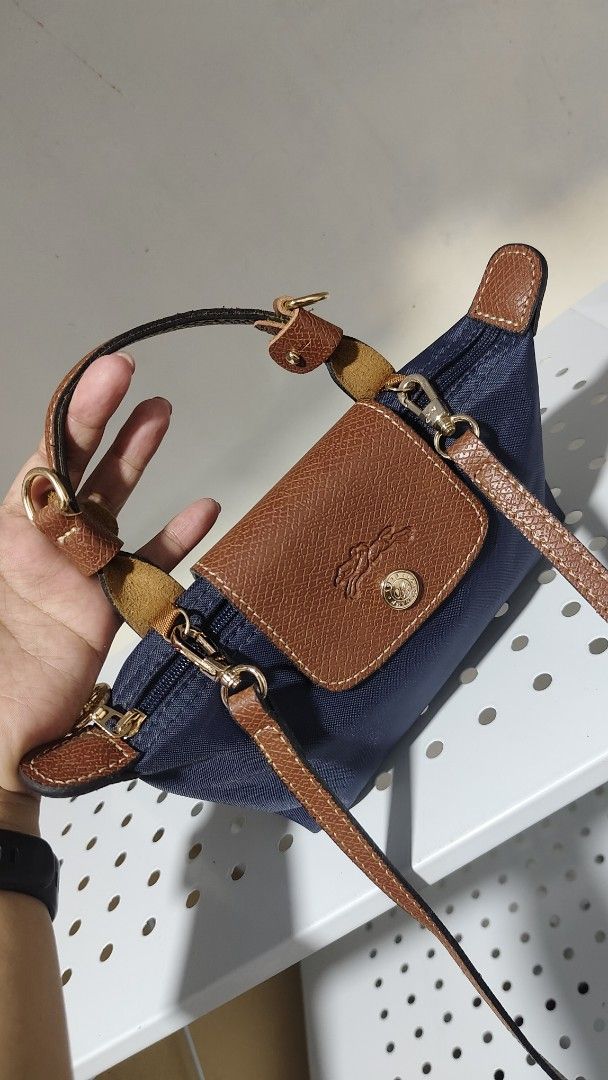 Longchamp Le Pliage Cuir Small Top Handle Bag Navy (Category: Luxury Bags & Wallets) located in Antipolo. Submitted by robannrave98496 (Listing ID 1460380719, Image 2). Description: - Navy blue Longchamp bag - Leather trim and handles - Detachable shoulder strap included - Gold hardware details - Perfect size for essentials - Great for daily use or travel.