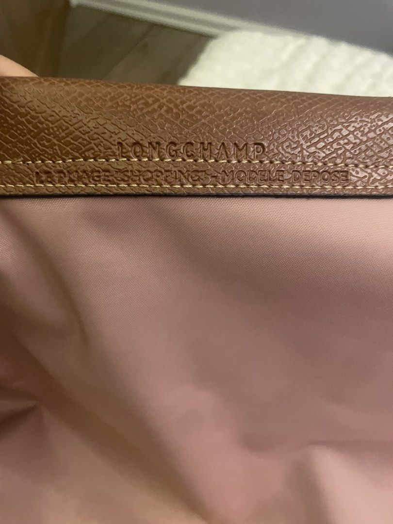 Longchamp Le Pliage Shopping Tote Bag (Category: Luxury Bags & Wallets) located in Manila. Submitted by mikay3laph (Listing ID 1460480026, Image 2). Description: - Authentic Longchamp tote bagbought in hk - Color: Pink nylon with brown leather trim - Iconic embossed horse logo on leather flap - Closure: Snap button and zip with horse zipper pull - Origin: Made in Tunisia - Ideal for everyday use.