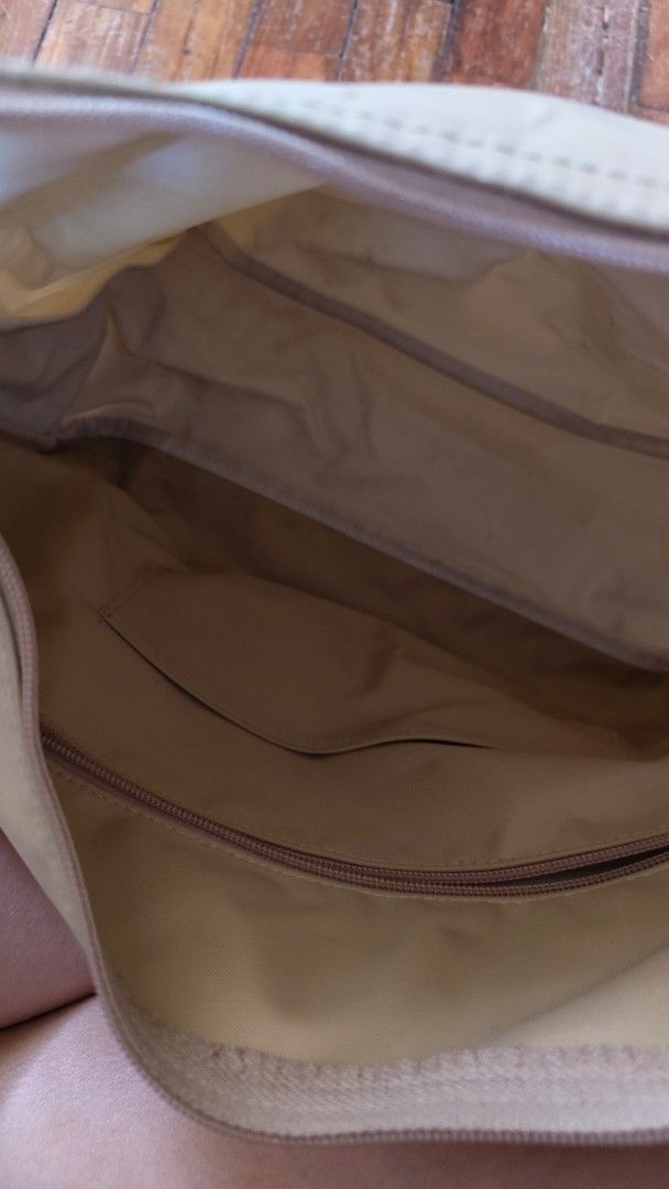 Longchamp Le Pliage Shoulder Bag Beige (Category: Luxury Bags & Wallets) located in Mandaluyong City. Submitted by nchllmnrd (Listing ID 1460399929, Image 3). Description: - Beige Longchamp Le Pliage shoulder bag - Durable nylon body with genuine leather trim - Secure zip closure - Multiple interior pockets for organization - Adjustable strap for comfortable wear - Spacious interior, ideal for everyday essentials - Versatile and practical for dai