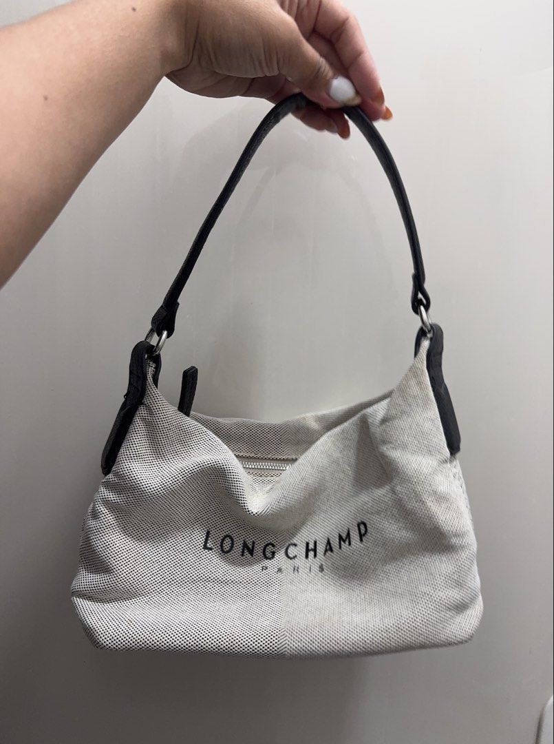 Longchamp Paris Canvas Leather Trim Shoulder Bag (Category: Luxury Bags & Wallets) located in Davao. Submitted by unabellac (Listing ID 1460364227, Image 1). Description: - Authentic Longchamp shoulder bag - Durable canvas material - Black leather trim - Classic Longchamp Paris logo - Secure zipper closure - Ideal for everyday use - Stylish and practical accessory.
