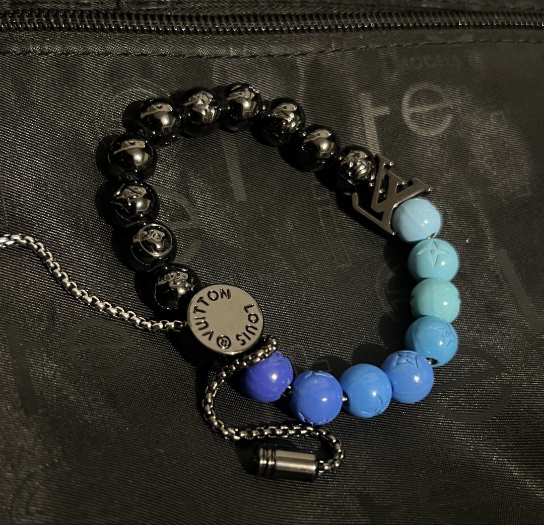 Louis Vuitton Monogram Beaded Bracelet (Category: Bracelets) located in Muntinlupa City. Submitted by katakana02 (Listing ID 1460453116, Image 1). Description: - Louis Vuitton bracelet - Features black and blue beads - Includes LV monogram pattern on select beads - Adorned with a larger LV charm - Adjustable chain closure.