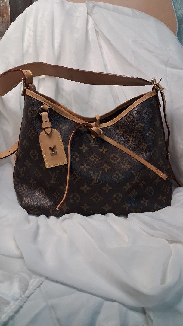 Louis Vuitton Monogram Shoulder Bag (Category: Luxury Bags & Wallets) located in Taguig. Submitted by divine_kitty (Listing ID 1460498581, Image 1). Description: - 9shoulder bag - Classic monogram canvas - Tan leather trim and strap - Secure zipper closure - Gold-tone hardware - Protective feet on the bottom - Ideal for everyday use.