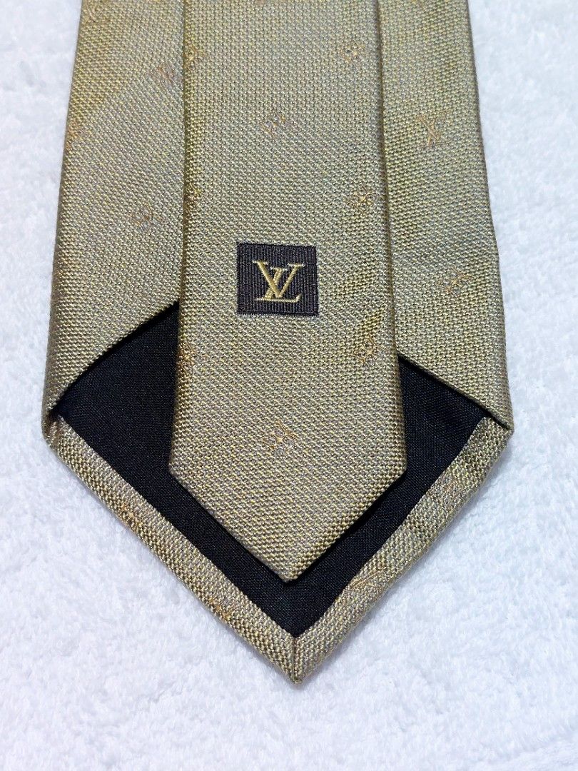 Louis Vuitton Necktie (Category: Luxury Accessories) located in Muntinlupa City. Submitted by sakurambo_des (Listing ID 1460475437, Image 2). Description: Louis Vuitton Necktie Made in Italy 100% Silk Color: Metallic Gold/warm metallic undertones appearance under the lighting. in very goog condition..