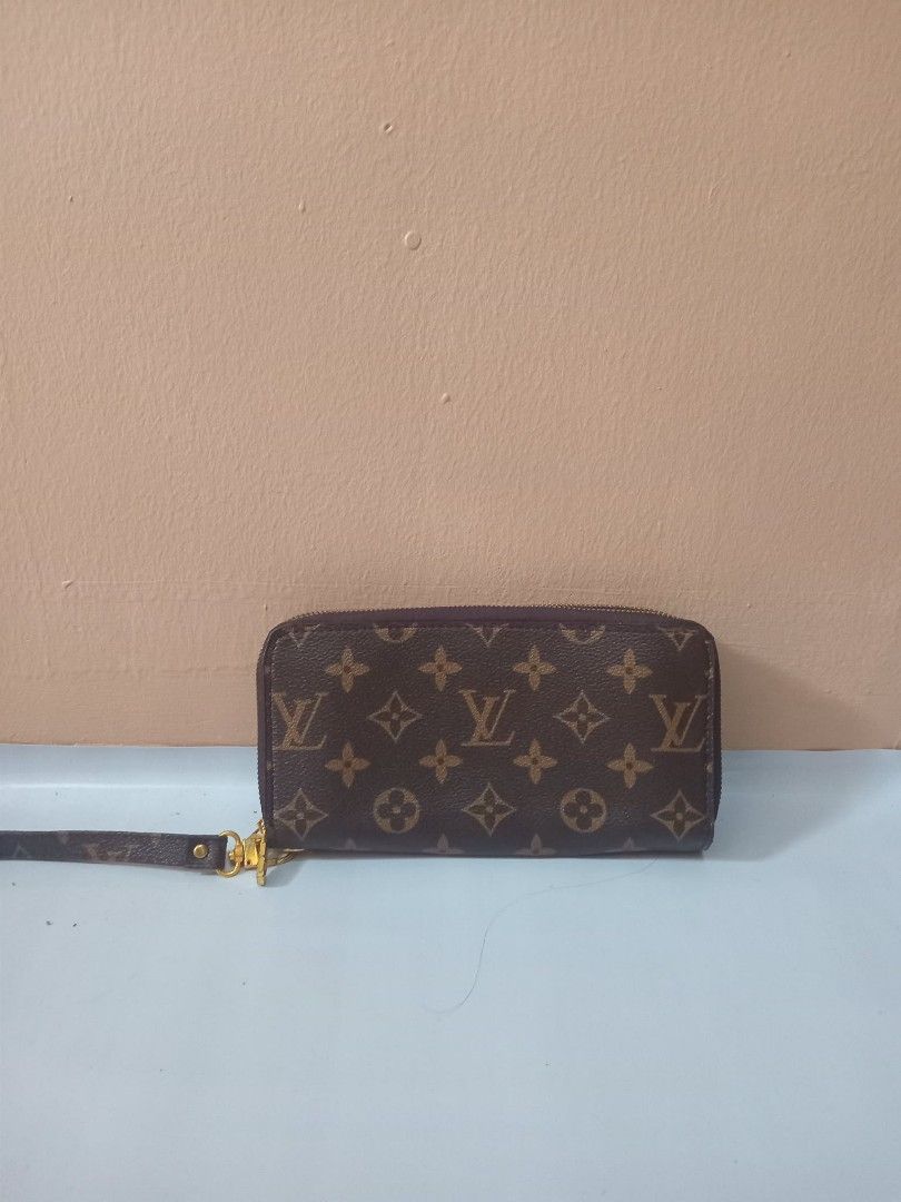 Lv Monogram Zip Around Wallet with Wristlet (Category: Luxury Bags & Wallets) located in Urdaneta. Submitted by assortedprelovedd (Listing ID 1460361033, Image 1). Description: - Classic Louis Vuitton monogram wallet - Zip-around closure - Detachable wristlet strap - Ample space for cards and cash - Timeless piece for everyday use - Gold-tone hardware.