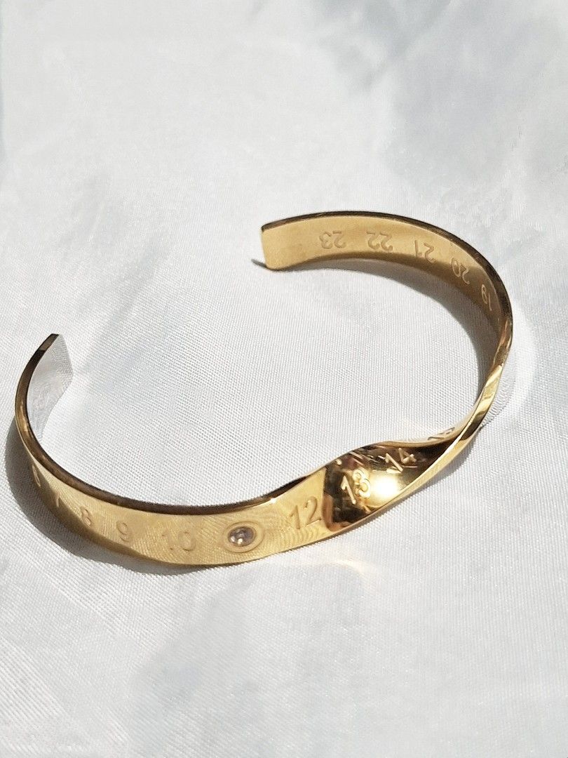 Maison Margiela Numeric Twisted Diamond Cuff Bracelet (Auth) (Category: Bracelets) located in Pasig City. Submitted by crazyrich.mnl (Listing ID 1460450750, Image 1). Description: Authentic📌 Thrifted 2nd Hand (has few small soft scratches) Rhinestone/Diamond Detail Intact. Men's size No box/inclusions, comes as is but alternative box will be provided for shipment purposes🫶🏻 Retails for $1,713 (P107,500) Message us for more info🤍 Open for offe