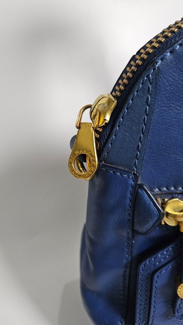 Marc by Marc Jacobs Blue Leather Satchel Handbag (Category: Luxury Bags & Wallets) located in Alfonso. Submitted by jbcamet (Listing ID 1460445189, Image 3). Description: - Marc by Marc Jacobs blue leather satchel - Elegant gold hardware details - Comfortable top handles - Secure zip closure - Includes a small leather tag - Spacious interior, ideal for daily essentials - Perfect everyday bag.