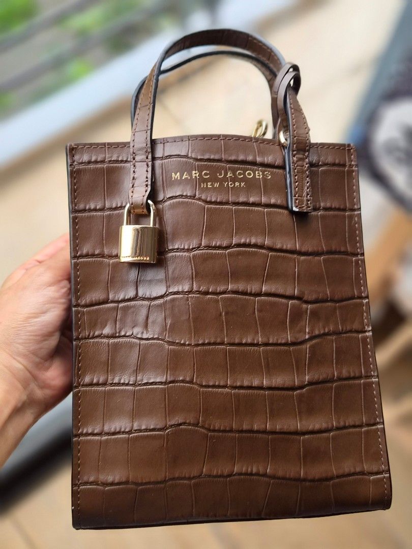 Marc Jacobs Brown Croc Embossed Lock Bag (Category: Luxury Bags & Wallets) located in Taytay. Submitted by passiveincome89 (Listing ID 1460505079, Image 1). Description: - Brand: Marc Jacobs - Color: Brown - Material: Croc-embossed leather - Features: Gold lock detail on the front - Handle: Top handle for carrying - Style: Simple, chic, versatile - Occasion: Great for everyday use or dressing up.
