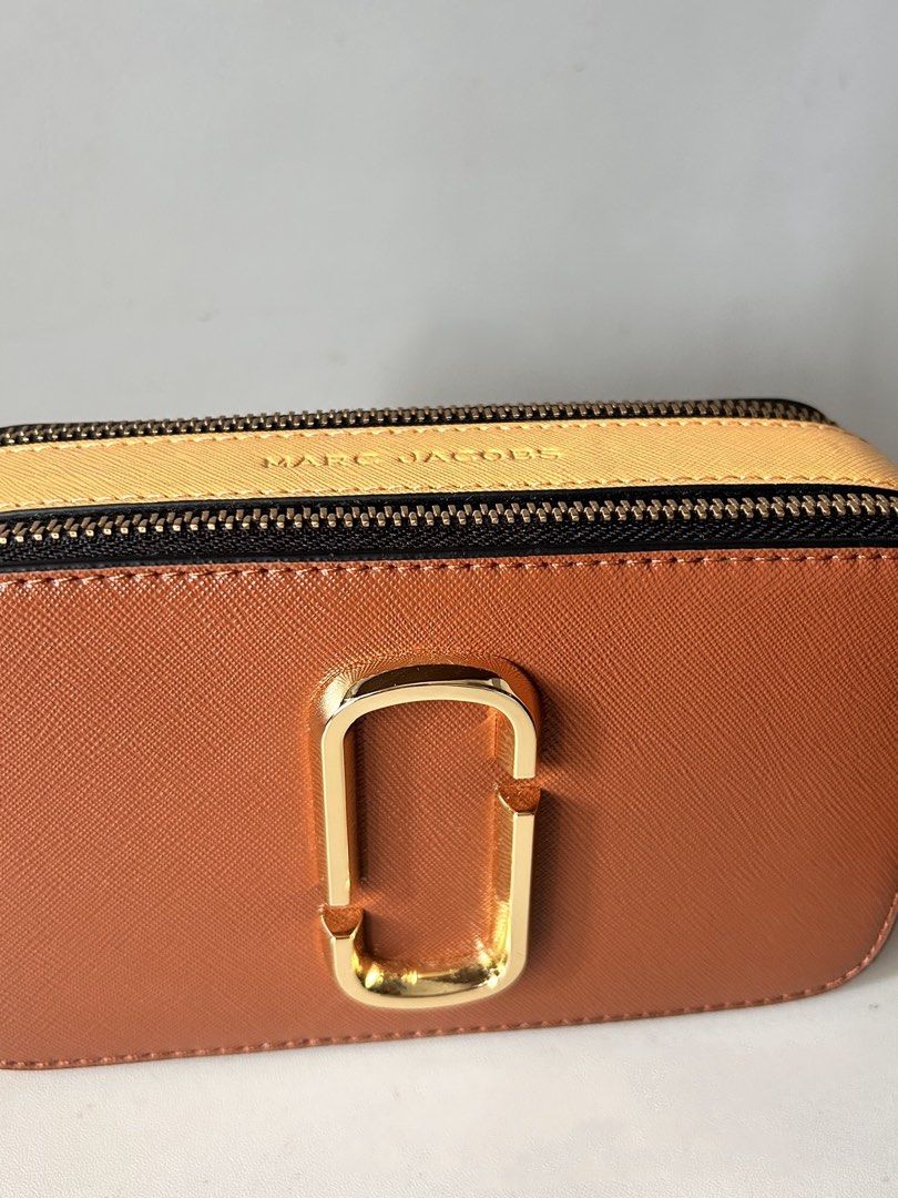 Marc Jacobs Snapshot Camera Bag Brown (Category: Luxury Bags & Wallets) located in Manila. Submitted by lyly_0 (Listing ID 1460308505, Image 3). Description: - Brown Marc Jacobs camera bag - Gold hardware - Includes wide logo strap - Zipper closure - Ideal for everyday use - Fits all your essentials.