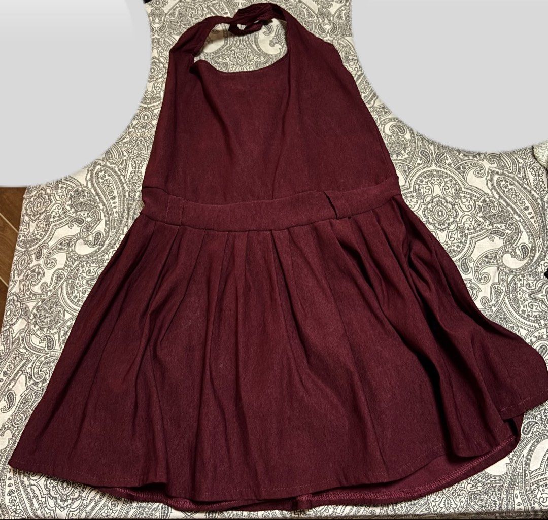 Maroon Halter Neck Pleated Dress (Category: Dresses) located in Trece Martires City. Submitted by decluttercloset_niks (Listing ID 1460410729, Image 2). Description: - Color may vary due to lighting - Maroon halter neck dress - Fitted waist with a pleated skirt - Built-in shorts for extra coverage and comfort.