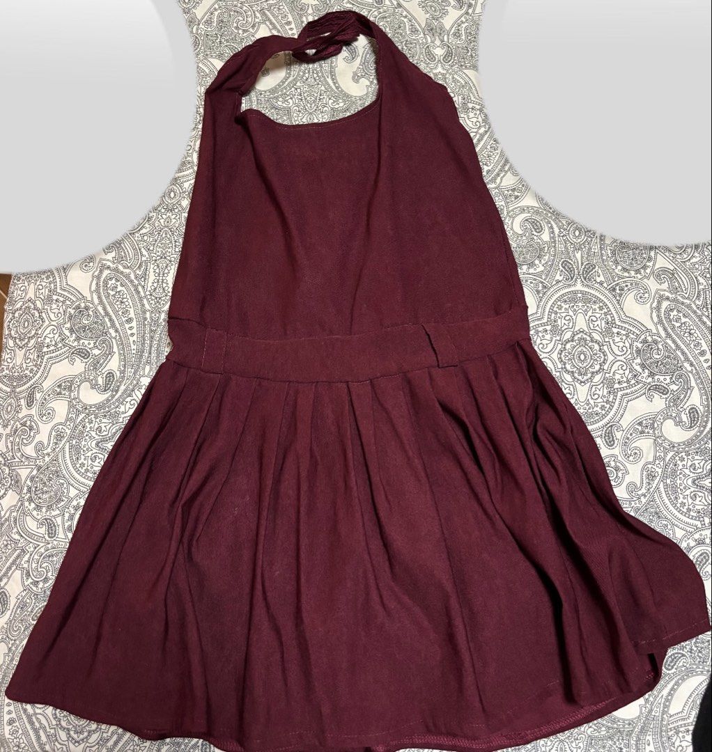 Maroon Halter Neck Pleated Dress (Category: Dresses) located in Trece Martires City. Submitted by decluttercloset_niks (Listing ID 1460410729, Image 1). Description: - Color may vary due to lighting - Maroon halter neck dress - Fitted waist with a pleated skirt - Built-in shorts for extra coverage and comfort.