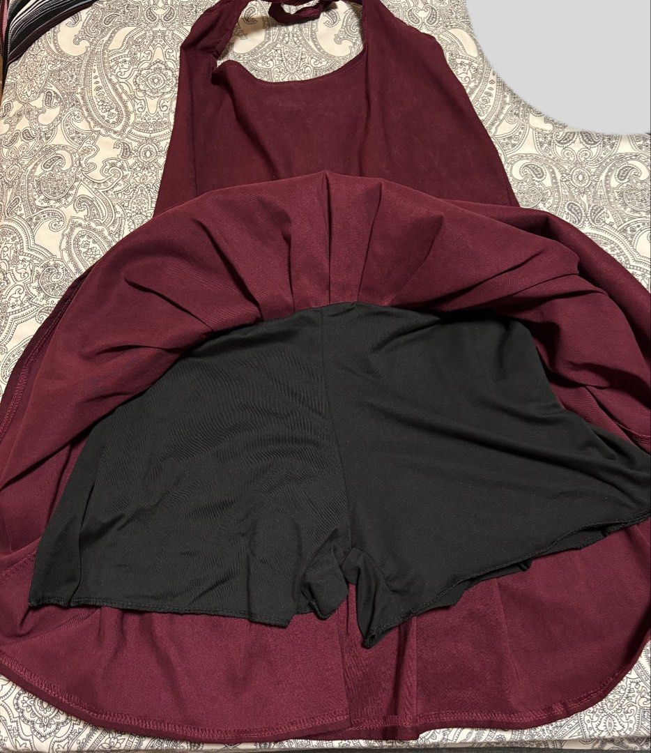 Maroon Halter Neck Pleated Dress (Category: Dresses) located in Trece Martires City. Submitted by decluttercloset_niks (Listing ID 1460410729, Image 3). Description: - Color may vary due to lighting - Maroon halter neck dress - Fitted waist with a pleated skirt - Built-in shorts for extra coverage and comfort.