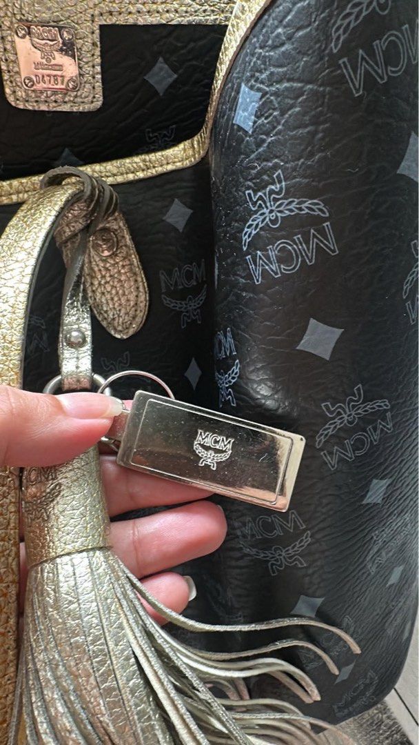 MCM Monogram Tote Bag with Matching Pouch (Category: Luxury Bags & Wallets) located in Manila. Submitted by mikaysabel (Listing ID 1460447718, Image 3). Description: - Authentic MCM tote bag - Signature monogram print - Elegant gold trim and handles - Includes a matching small pouch - Stylish tassel detail and MCM logo tag - Ideal for everyday use.