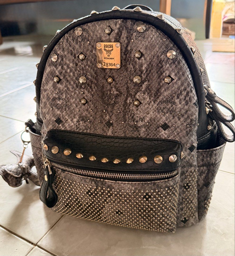 MCM Studded Python Print Backpack (Category: Backpacks) located in Puerto Princesa. Submitted by katsab (Listing ID 1460362293, Image 1). Description: 👜 FOR SALE: MCM Z8364 BAG 👜 ✨ Elegant and timeless MCM design ✨ Signature MCM monogram pattern ✨ Stylish and versatile—perfect for everyday use or special occasions ✨ Spacious enough for your essentials ✨ A must-have for MCM lovers and luxury bag collectors 📩 Send me a message for more details, 