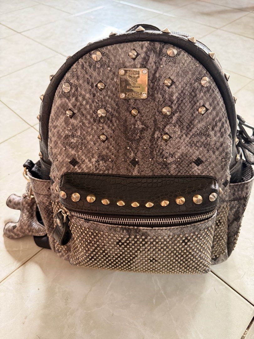 MCM Studded Python Print Backpack (Category: Backpacks) located in Puerto Princesa. Submitted by katsab (Listing ID 1460362293, Image 3). Description: 👜 FOR SALE: MCM Z8364 BAG 👜 ✨ Elegant and timeless MCM design ✨ Signature MCM monogram pattern ✨ Stylish and versatile—perfect for everyday use or special occasions ✨ Spacious enough for your essentials ✨ A must-have for MCM lovers and luxury bag collectors 📩 Send me a message for more details, 