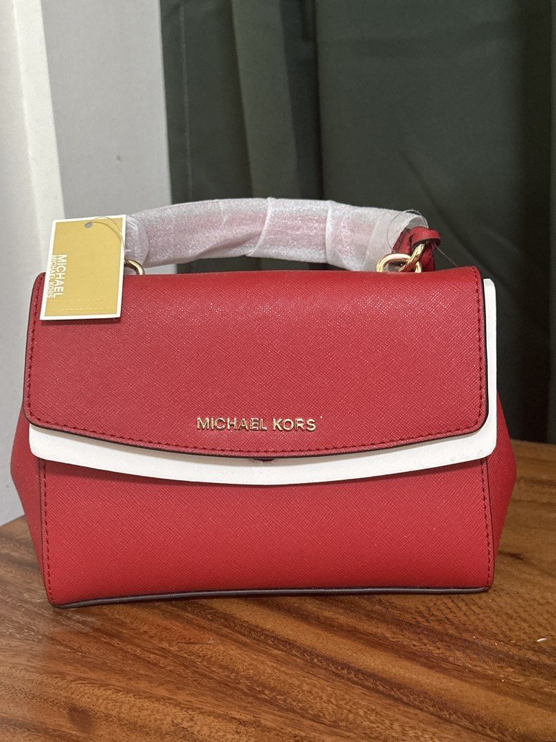 Michael Kors Crimson Leather Handbag (Category: Luxury Bags & Wallets) located in Makati City. Submitted by macalinaojr (Listing ID 1460363450, Image 1). Description: - Genuine crimson leather crossbody bag - Chic white trim detail - Elegant gold hardware - Comes with a detachable shoulder strap - Brand new with original tags attached - Versatile for everyday or special events.