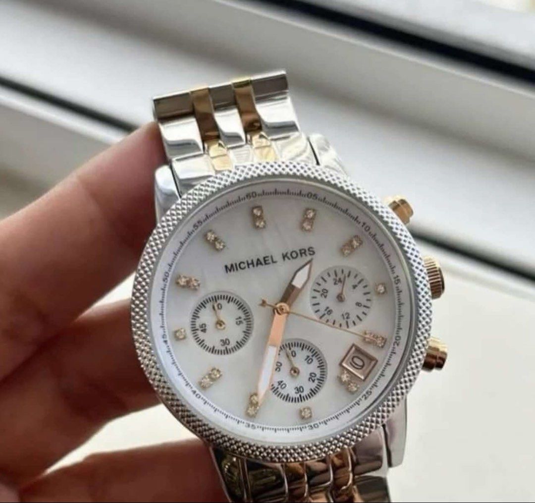 Michael Kors Two-Tone Chronograph Watch (Category: Luxury Watches) located in Manila. Submitted by vineshrubs75 (Listing ID 1460325340, Image 3). Description: - Like new Michael Kors chronograph watch -Mother pearl color - Two-tone stainless steel case and bracelet - Crystal hour markers for a touch of sparkle - Features a date display - Reliable quartz movement - A classic, versatile accessory to elevate any outfit - Price is negotiable - Please