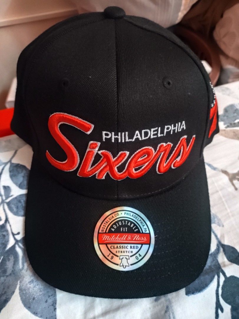 Mitchell & Ness Philadelphia 76ers Classic Red Stretch Snapback Cap (Category: Caps & Hats) located in Dasmarinas. Submitted by rocksteadypao0315 (Listing ID 1460357636, Image 1). Description: - Brand: Mitchell & Ness - Team: Philadelphia 76ers - Color: Black with red accents - Front Design: Red script team name - Side Design: Classic 76 logo - Fit: Adjustable stretch snapback - Underbrim: Red - Ideal for: Any 76ers fan.
