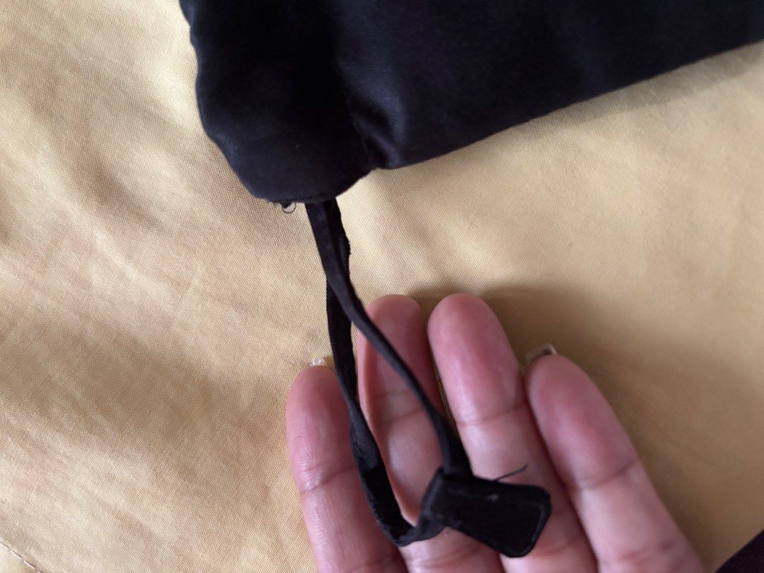 Miu Miu Black Satin Drawstring Pouch (Category: Purses & Pouches) located in Manila. Submitted by livfindsph (Listing ID 1460305120, Image 3). Description: - Authentic Miu Miu black satin pouch - Secure drawstring closure - Small Miu Miu logo tag on the front - Ideal for storing jewelry, coins, or other small items - Compact size: approximately 4x5 inches - Interior and exterior are clean and well-maintained.