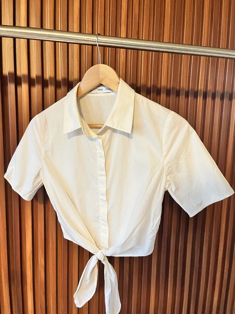 MNG White Cropped Tie-Front Shirt (Category: Shirts) located in Echague. Submitted by aeafitz (Listing ID 1460304823, Image 1). Description: - MNG white short-sleeve shirt - Collared neckline - Tie-front detail at hem - Easy to style for casual or dressed-up outfits - Perfect with high-waisted bottoms.