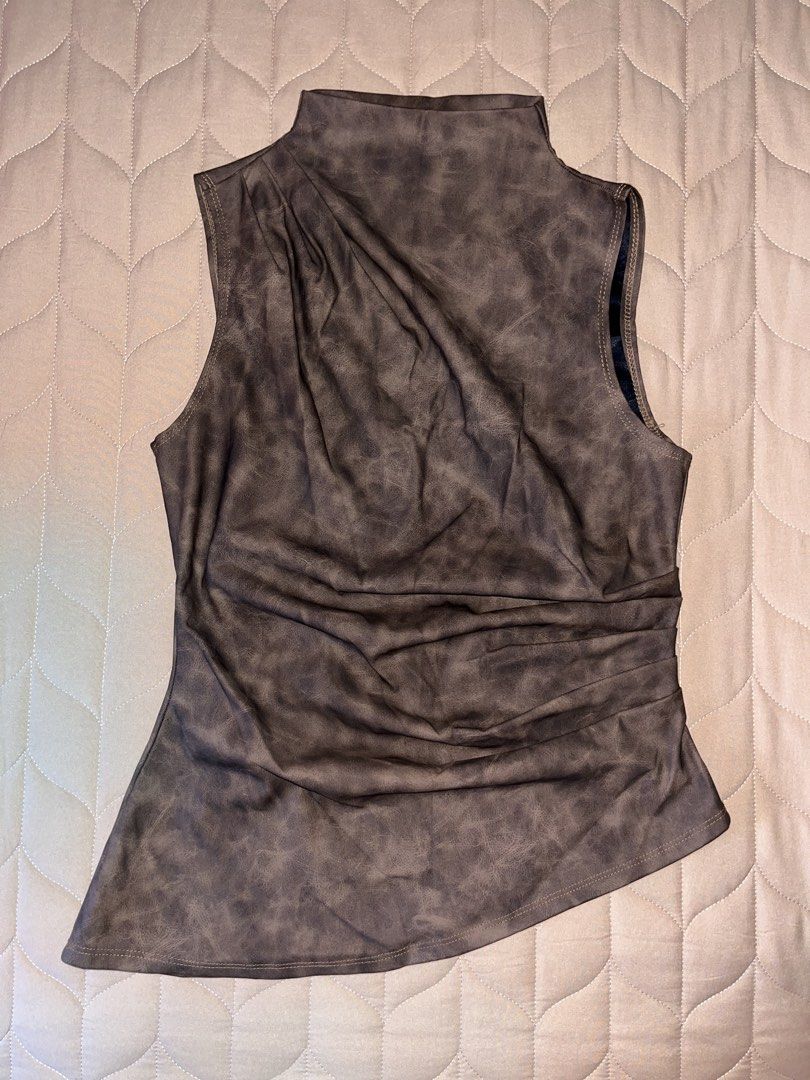 Mock Neck Ruched Top (Category: Sleeveless) located in Taguig. Submitted by novealiennn (Listing ID 1460385885, Image 1). Description: - Dark brown sleeveless top - Mock neck with front and side ruching - Asymmetrical hemline - Faux leather appearance - Versatile for dressing up or down.