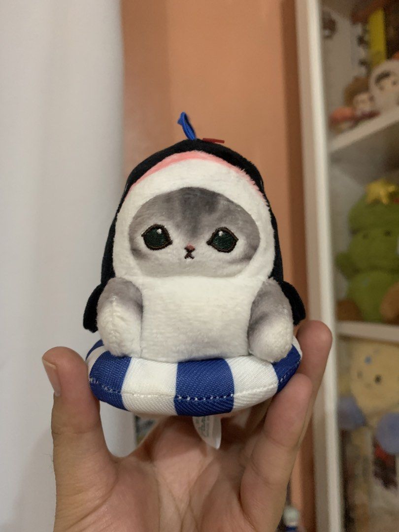 Mofusand Penguin Cat Plush with Ring Float (Category: Plushies & Soft Toys) located in Tagaytay City. Submitted by jujujewel (Listing ID 1460370348, Image 1). Description: - Adorable Mofusand plush toy - Features a cat dressed as a penguin - Sits on a blue and white striped ring float - Includes a small blue loop on top - Approximately 4 inches tall - Ideal for Mofusand collectors - Makes a cute desk accessory.