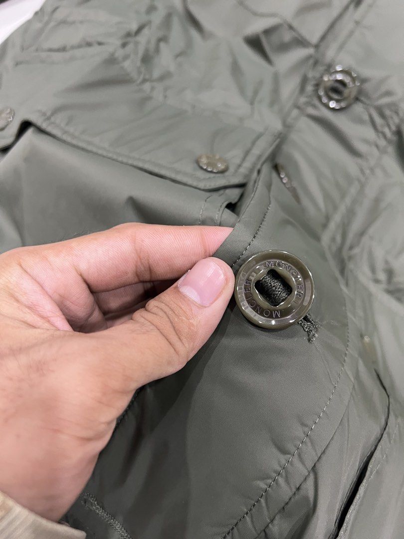 Moncler Olive Green Military Style Jacket (Category: Coats, Jackets and Outerwear) located in Manila. Submitted by royalbear-872f8c (Listing ID 1460393949, Image 3). Description: - Olive green Moncler jacket - Military-inspired design - Multiple functional pockets - Secure button and zip closure - Iconic Moncler logo on sleeve - Ideal for layering in cooler weather - Please check photos for detailed condition.