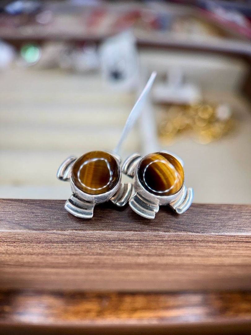 Natural Tiger’s Eye in Vintage Silver Setting (Category: Earrings) located in Baguio. Submitted by asna_taku (Listing ID 1460430815, Image 2). Description: 🐅 Natural Tiger’s Eye in Vintage Silver Setting A bold vintage find with that mesmerizing golden-brown glow. ✨ Featuring natural Tiger’s Eye cabochons with a beautiful chatoyant band that shifts as it catches the light. Set in a distinctive vintage silver design, these studs have a strong, ti
