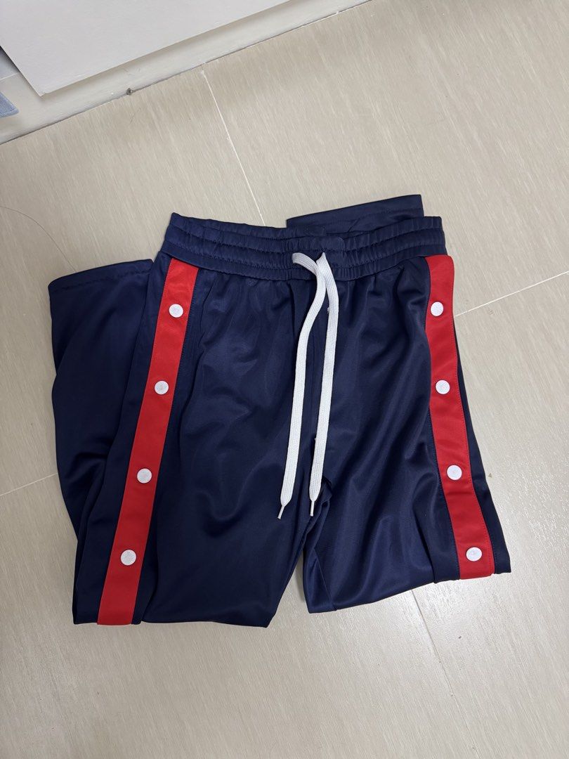 Navy Blue Track Jacket and Pants Set with Red Stripes (Category: Sets or Coordinates) located in Manila. Submitted by nathalietotanes (Listing ID 1460332381, Image 2). Description: - Navy blue track suit set - Cropped zip-up jacket - Pants with snap buttons on sides - Red stripe detail with white dots on both pieces - Elastic waistband with drawstring on pants - Ideal for casual wear or sports.