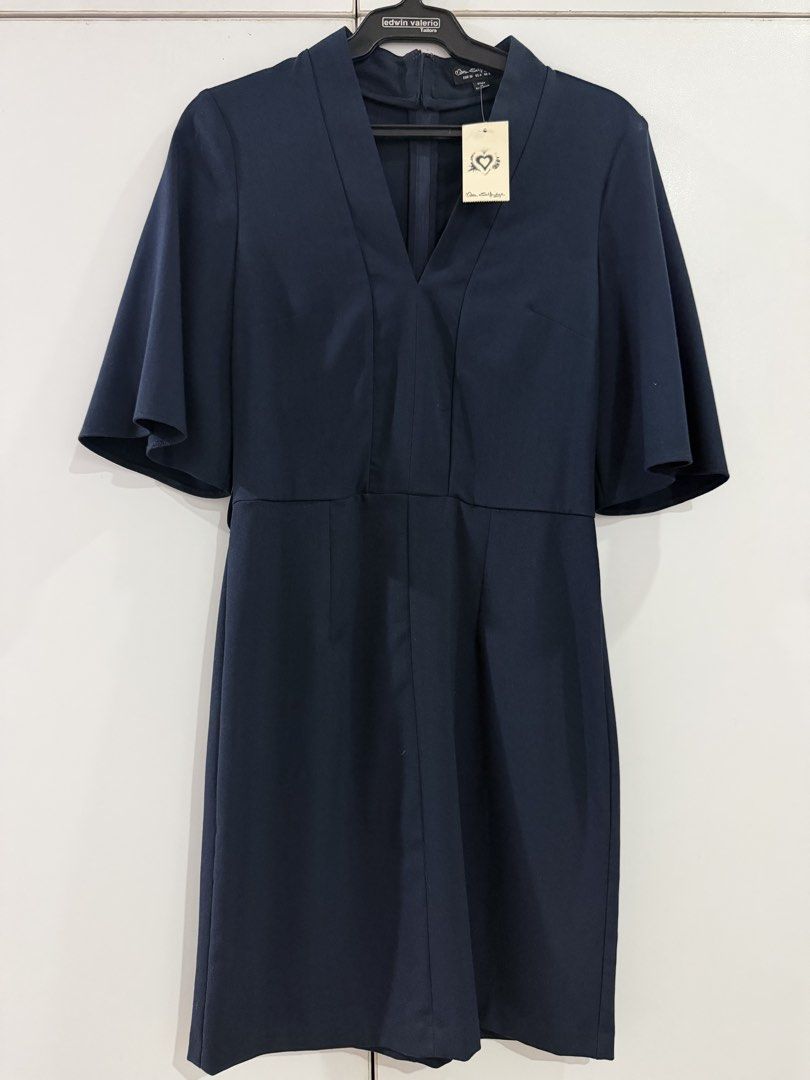 Navy Blue V-Neck Flutter Sleeve Dress (Category: Dresses) located in Manila. Submitted by nicolebrave (Listing ID 1460416746, Image 1). Description: - Navy blue V-neck dress - Flutter sleeves - Knee-length - Fitted waist - Back zip closure - Versatile for work or casual outings - Simple and classic design.